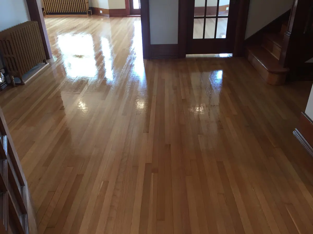 The same entry hall after refinishing, with an even sheen