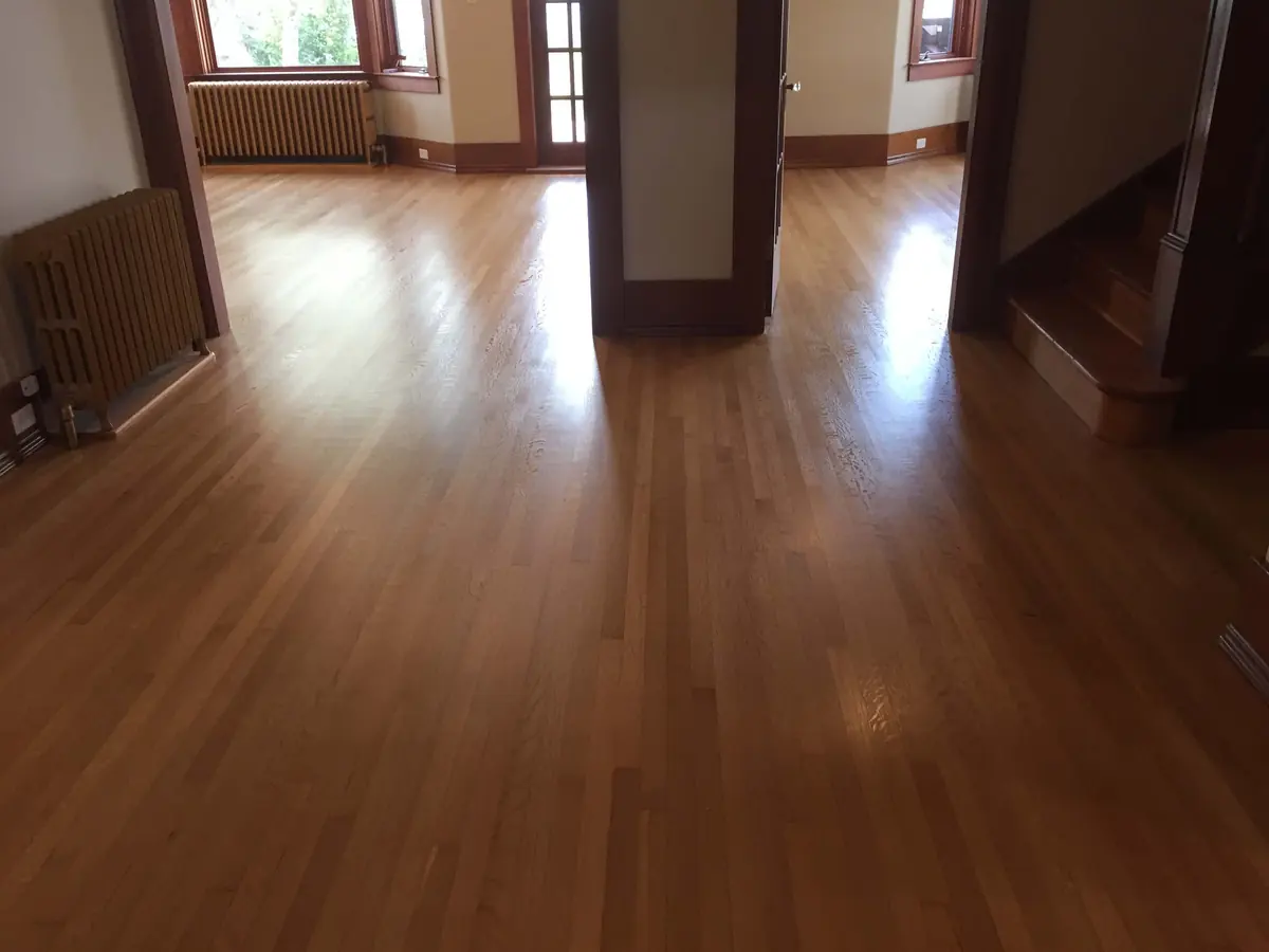 Worn entry hall floor with a dull, patchy finish