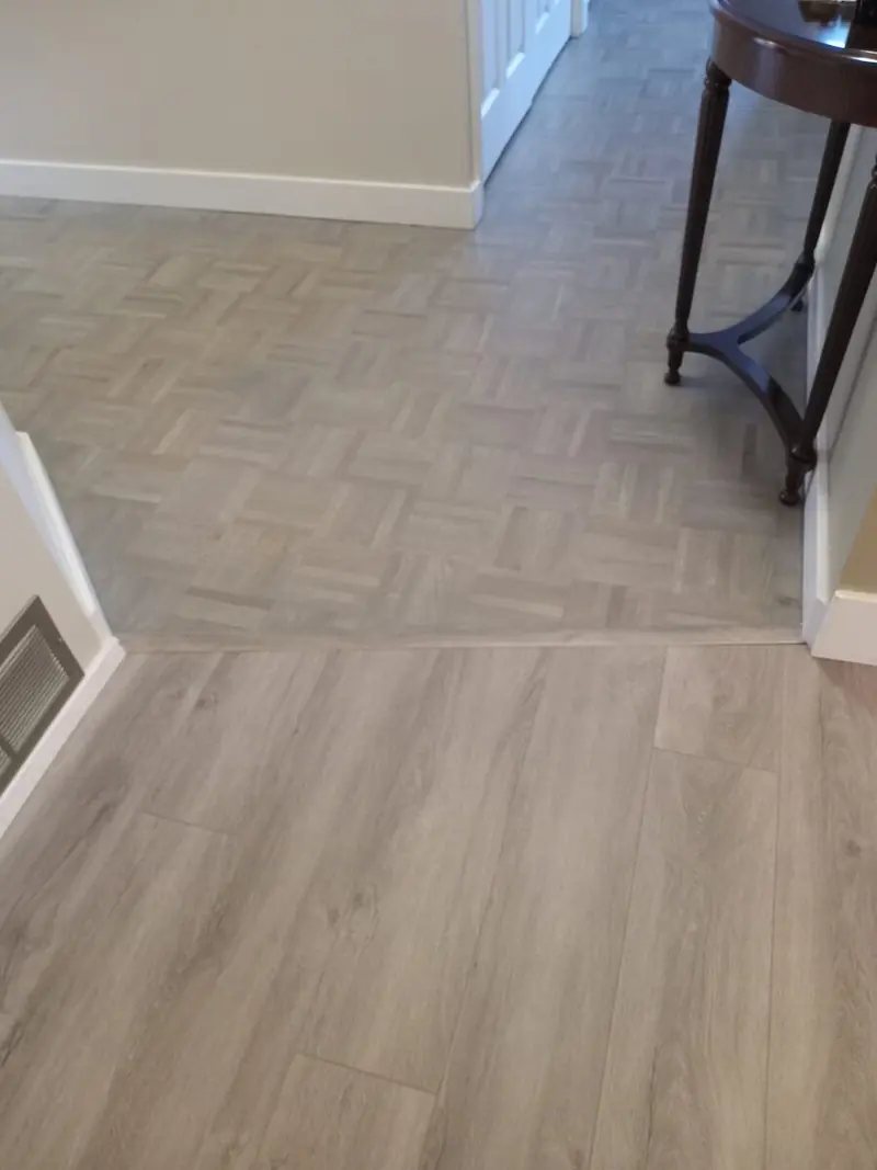 Custom stained parquet flooring matched to adjoining plank flooring